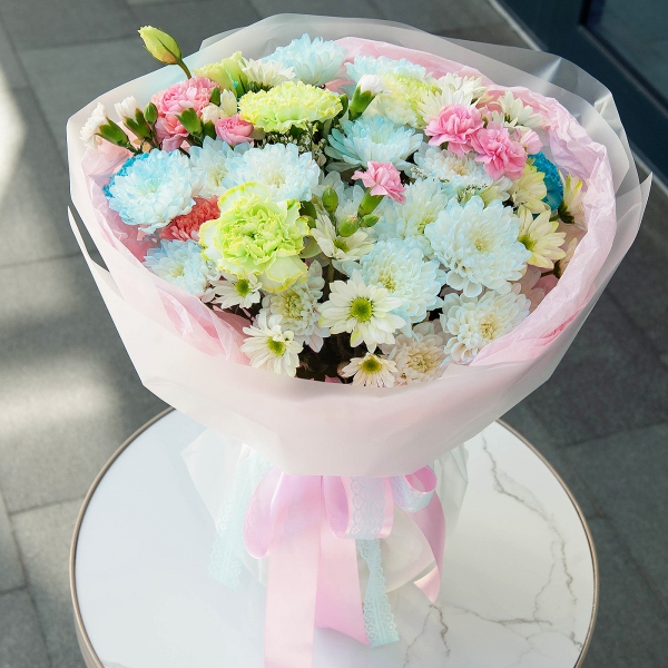Chrysanthemum spray Baltica painted blue - 4, Pink carnation - 2, Carnation white, cream - 6, Bacardi Yellow Spray Chrysanthemum - 4, Pink spray carnation - 4, Limonium (1 pc.), Wrapping Paper