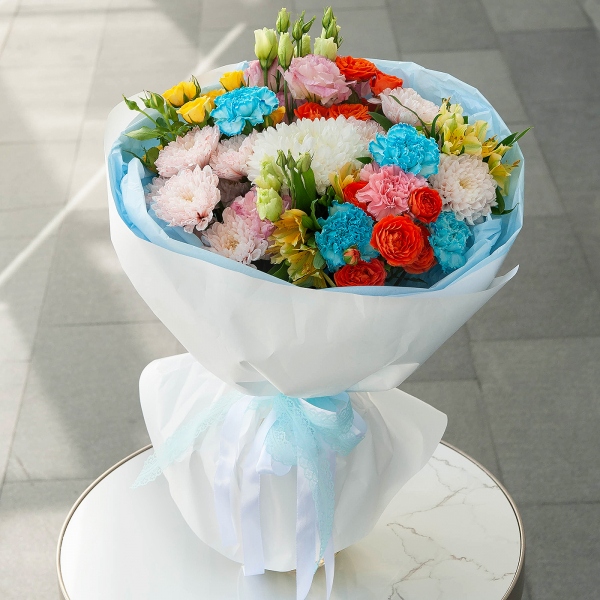 Baltica Pink Spray Chrysanthemum - 2, Magnum White Chrysanthemum - 1, Pink carnation - 1, Carnation white, cream - 4, Pink Lisianthus (Eustoma) - 2, Alstromeria Yellow, Orange - 2, Spray rose: yellow, orange 50 cm - 3, Wrapping Paper