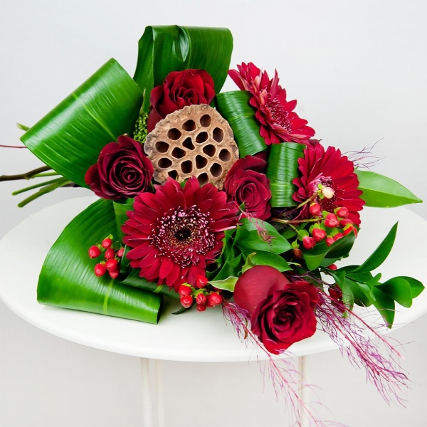 Red rose 50 cm - 5, Gerbera red - 3, Ruscus, Aspidistra (1 pc.), Hypericum, Skimmia, Dried flowers decor, Ribbon