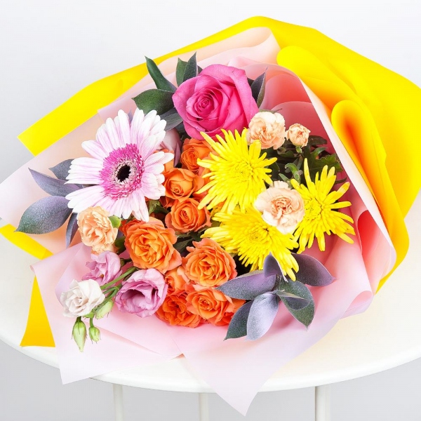 Spray rose: yellow, orange 50 cm - 2, Pink spray carnation - 2, Baltica Yellow Spray Chrysanthemum - 2, Pink Lisianthus (Eustoma) - 1, Gerbera pink - 1, Pink rose 50 cm - 3, Ruscus, Wrapping Paper