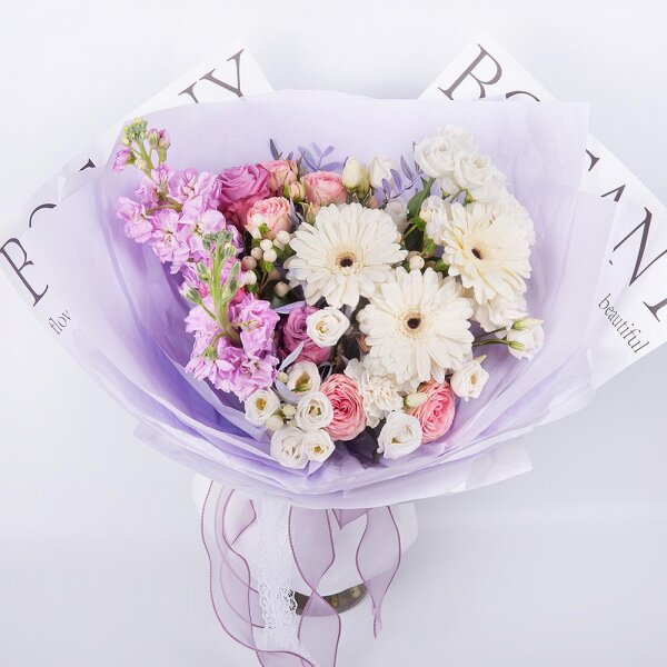 Gerbera white - 3, Pink rose 50 cm - 3, Peony sprayrose - 2, Carnation white, cream - 3, Matthiola Lilac - 2, lisianthus - 3, Hypericum, Pistachio, Wrapping Paper