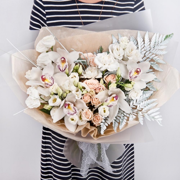 White Cymbidium Orchid Bud - 5, Spray rose: white, cream, light pink 50 cm - 6, Carnation white, cream - 4, lisianthus - 3, Flask for orchids, Fern (1 pc.), Beargrass (1 pc.), Wrapping Paper