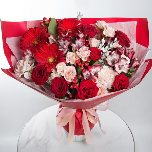 Gerbera red - 3, Red rose 50 cm - 7, Spray rose: white, cream, light pink 50 cm - 3, Alstromeria Red, Bright Pink - 5, Carnation white, cream - 3, Hypericum, Pistachio, Wrapping Paper