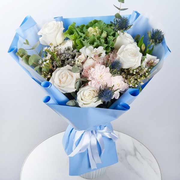 White rose 50 cm - 5, Baltica Pink Spray Chrysanthemum - 2, Alstromeria white, soft pink - 1, Brassica, Eryngium, Brunia Green Lanuginosa (1 pc.), Waxflower (1 pc.), Eucalyptus, Wrapping Paper