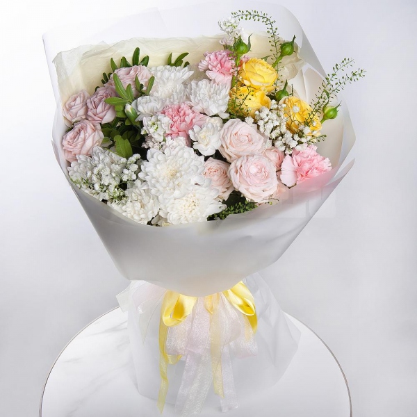 Baltica White Spray Chrysanthemum - 2, Peony sprayrose - 2, Pink carnation - 3, White spray carnation - 2, White Matthiola - 2, Gypsophila - 1, Spray rose: yellow, orange 50 cm - 1, Pistachio, Green bell (1 pc.), Wrapping Paper
